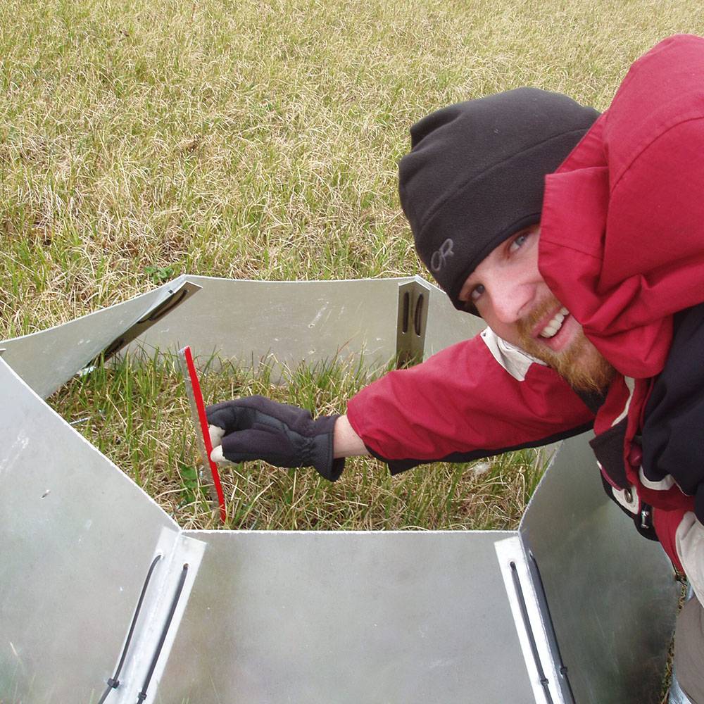 Michael smiles while he measures plants.